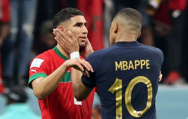 France's forward #10 Kylian Mbappe comforts Morocco's defender #02 Achraf Hakimi at the end of the Qatar 2022 World Cup semi-final football match between France and Morocco at the Al-Bayt Stadium in Al Khor, north of Doha on December 14, 2022. (Photo by KARIM JAAFAR / AFP)