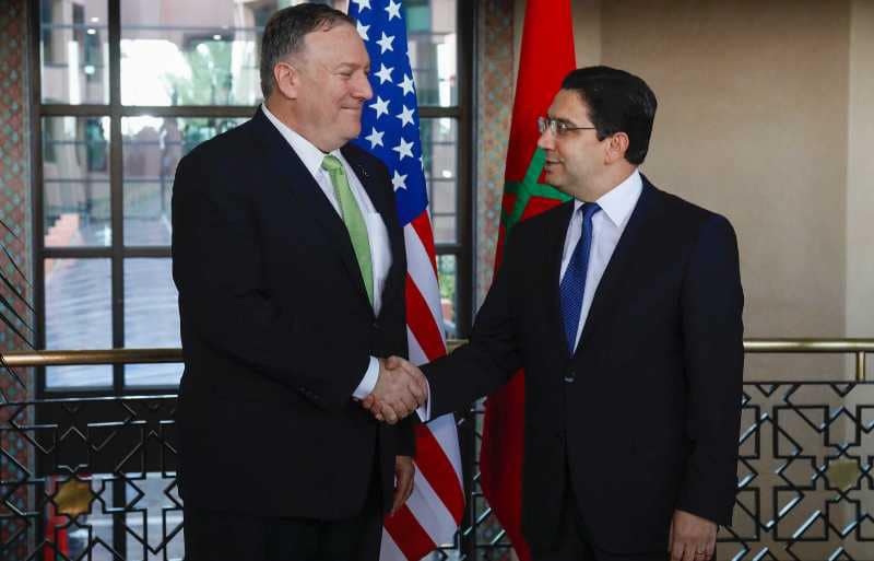 US Secretary of State Mike Pompeo is welcomed by Morocco's Foreign Minister Nasser Bourita (R) during his visit to Rabat on December 5, 2019. - Pompeo visited Morocco as the highest-ranking American official to travel there since the election of President Donald Trump. The State Department has called Morocco an "essential partner" in the US diplomatic strategy in the region, which aims for the normalisation of ties between Arab countries and Israel. (Photo by - / AFP)